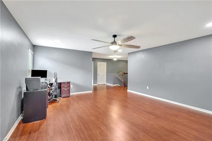 Unfurnished office with light wood-type flooring and ceiling fan