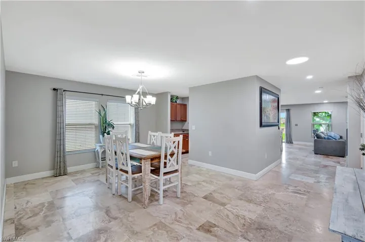 Dining space with a chandelier and recessed lighting