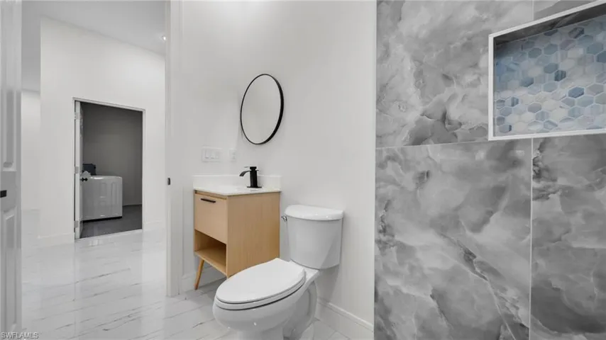 Bathroom with vanity and light marble finish flooring