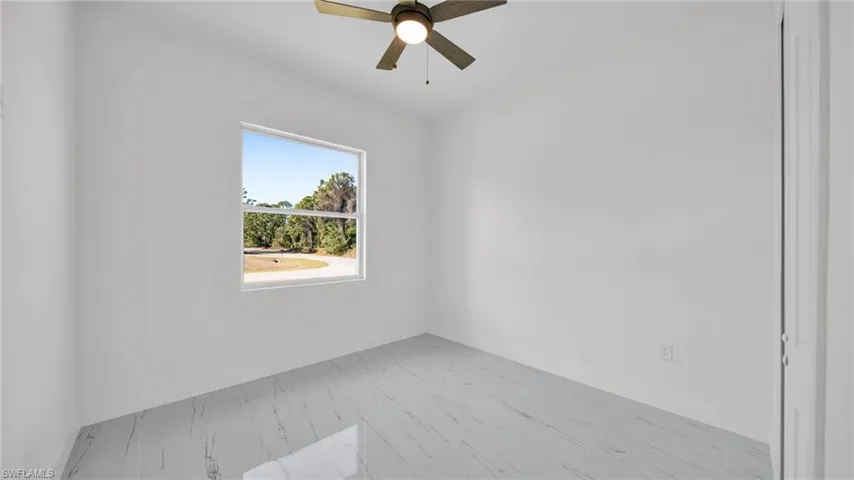 Empty room featuring ceiling fan