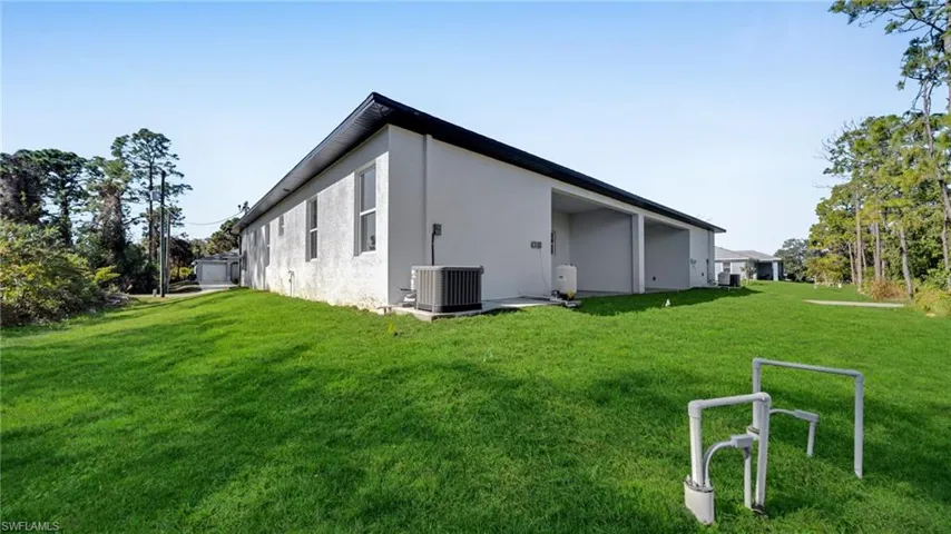 View of home's exterior featuring a lawn and stucco siding