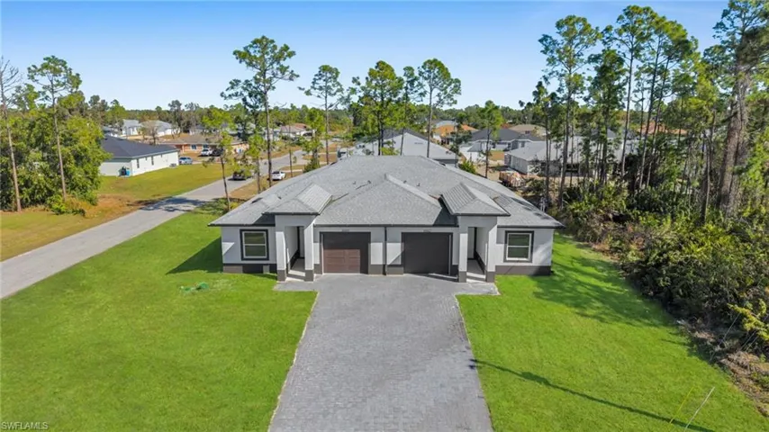 View of front of property with a shingled roof, a residential view, and a front yard