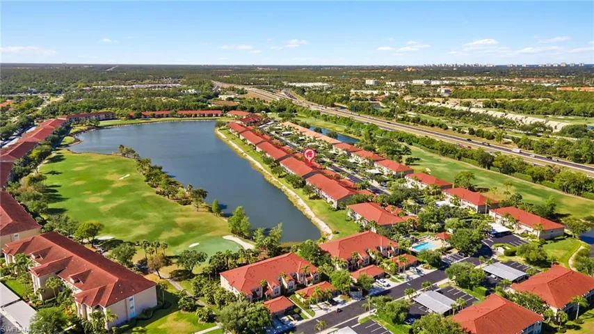 Aerial view with a water view, a residential view, and view of golf course