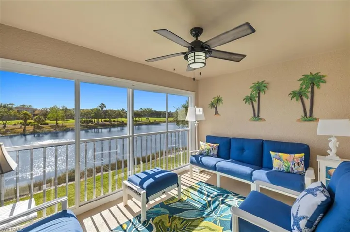 Enclosed lanai featuring water and golf view.