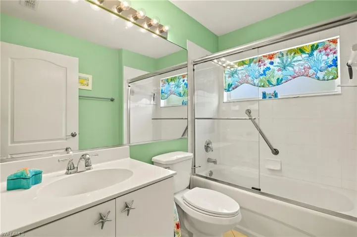 Another corner unit window adding natural light to this adorable guest bath.
