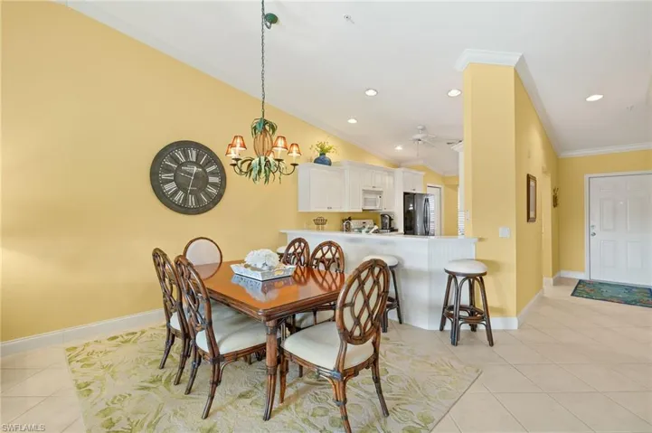Dining space featuring baseboards, recessed lighting, light tile patterned flooring, and crown molding