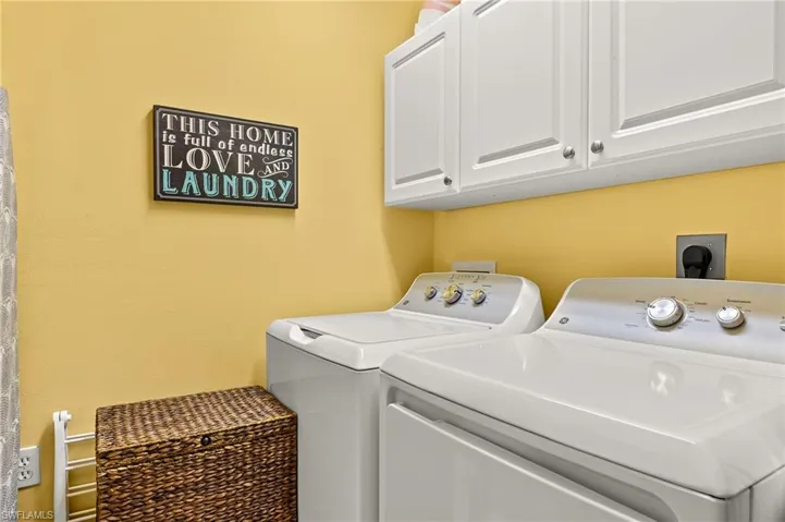 Clothes washing area with washer, dryer and cabinet space