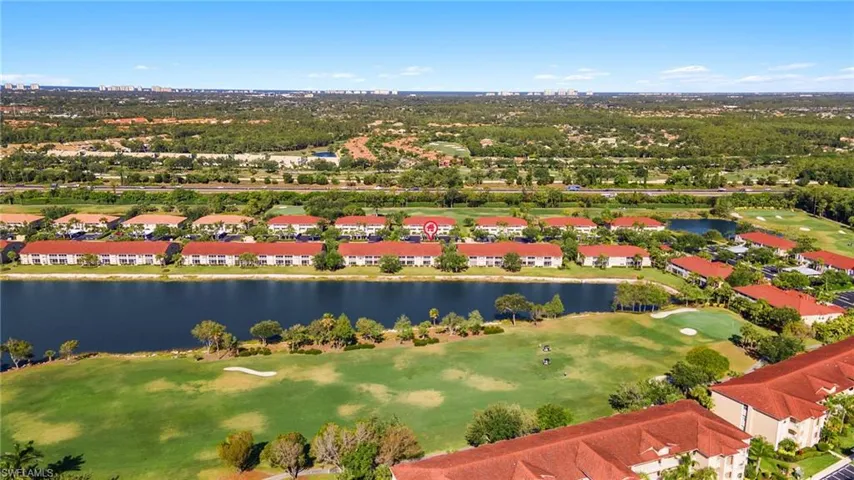 Birds eye view of property featuring golf course view, a residential view, and a water view