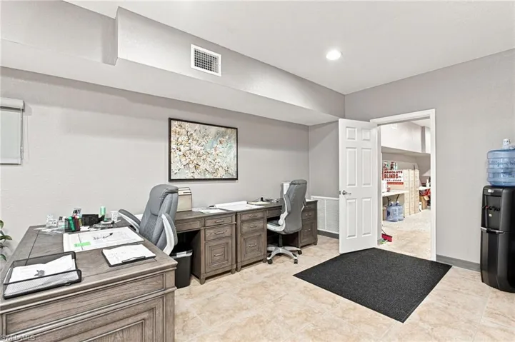 Recessed ceiling lighting, light-toned wall finishes, paneled interior door, and tiled flooring