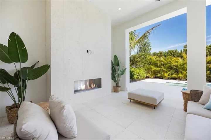 The outdoor covered living area features natural gas fireplace on one end and natural gas grill, sink, and under counter refrigerator on the other. All lanai openings have been prewired for the option of adding motorized roll-down screens after closing.