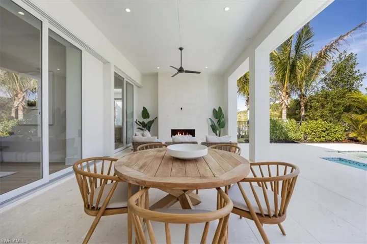 The outdoor covered living area features natural gas fireplace on one end and natural gas grill, sink, and under counter refrigerator on the other. All lanai openings have been prewired for the option of adding motorized roll-down screens after closing.