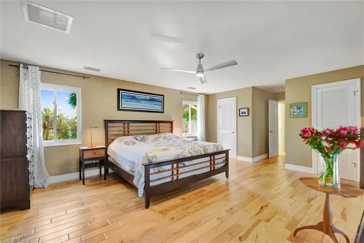Bedroom with light wood-style floors and a ceiling fan