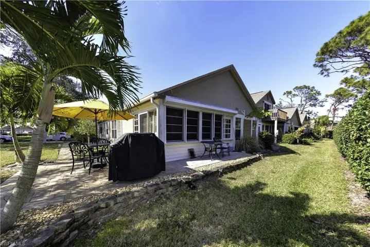 Covered porch entry featuring square tile flooring and a solid paneled door with a sidelight window