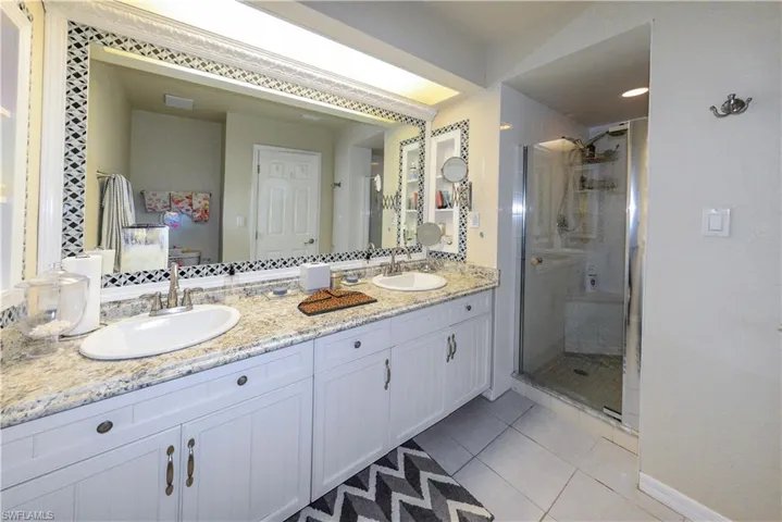 Dedicated laundry area featuring a built-in countertop, upper cabinetry, and a full wall of integrated storage units