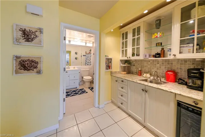 Recessed lighting, wood-finish flooring, and louvered bifold closet doors