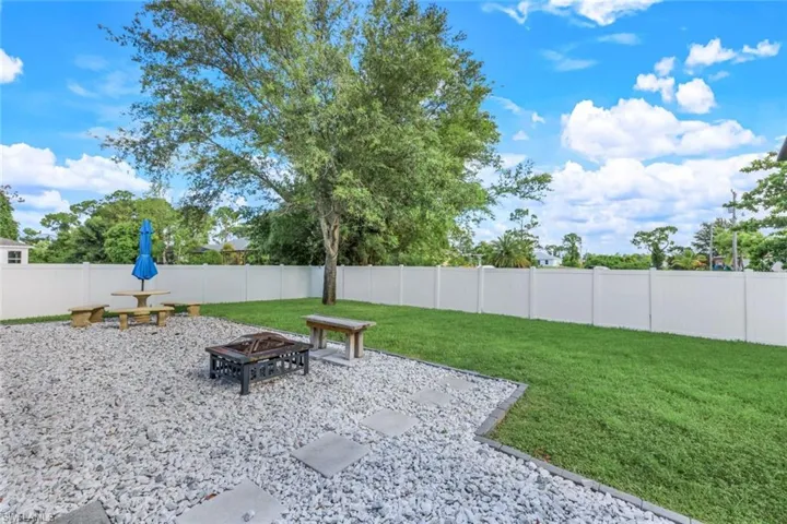 View of yard with a patio and an outdoor fire pit