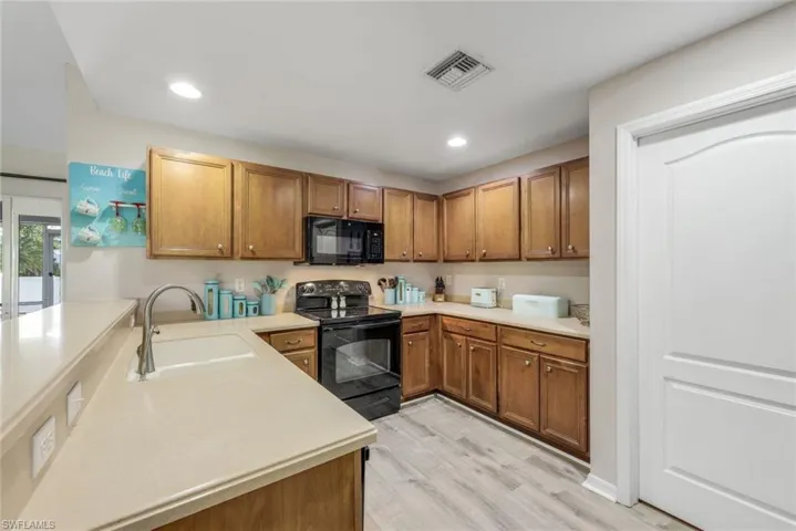 Kitchen featuring GE Appliances, Pantry and Breakfast Bar.