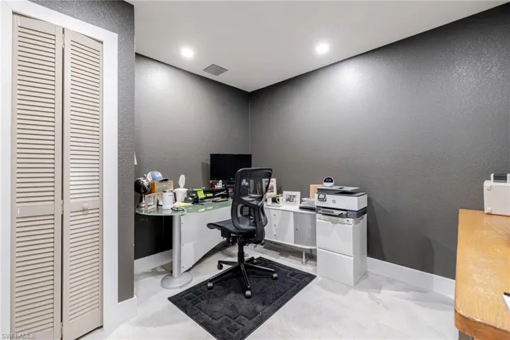 Office space with a textured wall and recessed lighting