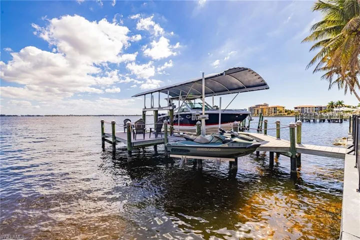 Dock featuring a water view and boat lift