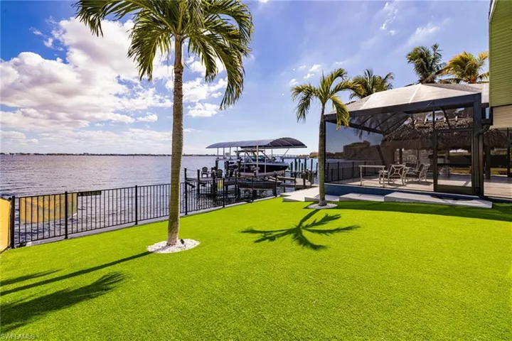 Dock featuring boat lift, a water view, and a gazebo