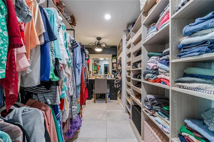 Walk in closet with light tile patterned floors