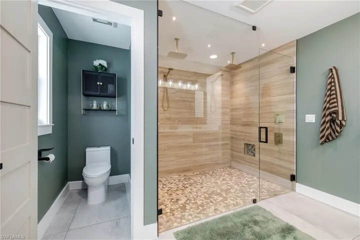 Bathroom featuring tile patterned floors and a stall shower
