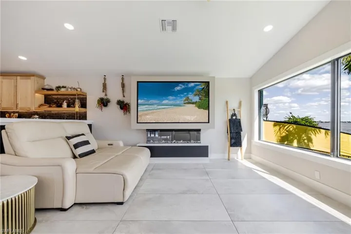 Home theater room featuring recessed lighting and vaulted ceiling