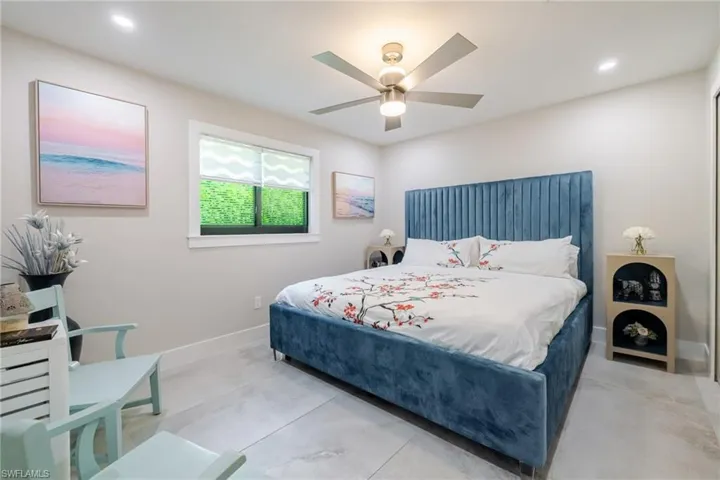 Bedroom with recessed lighting, a ceiling fan, and concrete flooring