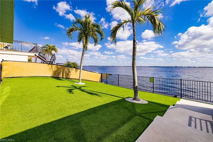 View of yard featuring a water view and a patio area
