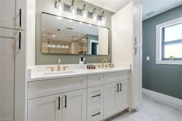Bathroom with double vanity and a tile shower