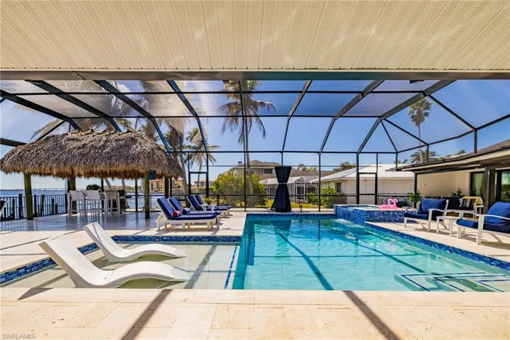Integrated pool / hot tub with a patio area, a lanai, and a sunroom
