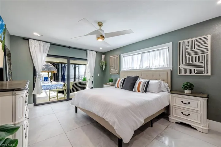 Bedroom with access to exterior, a ceiling fan, and recessed lighting