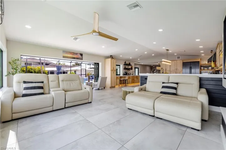 Living room featuring recessed lighting, vaulted ceiling, and ceiling fan