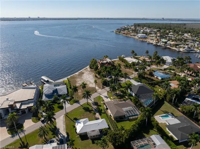 Aerial view of property's location featuring nearby suburban area and a nearby body of water