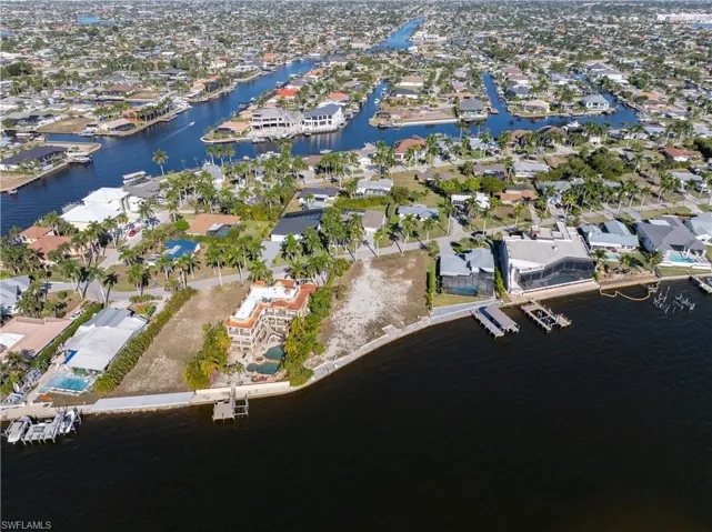 Aerial overview of property's location featuring nearby suburban area and a large body of water