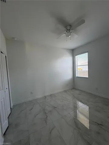 Empty room with light marble finish flooring and baseboards