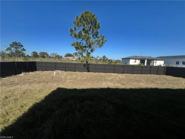 View of fenced backyard