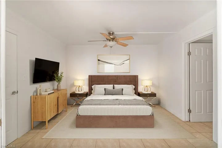Tiled bedroom with ornamental molding and ceiling fan