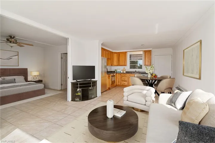 Living area with light tile patterned floors and a ceiling fan