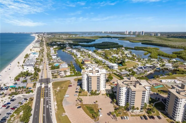 Aerial view of property and surrounding area featuring a nearby body of water and nearby urban area