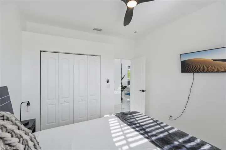Bedroom with visible vents, a closet, and a ceiling fan