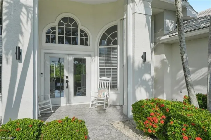 Property entrance with stucco siding and french doors