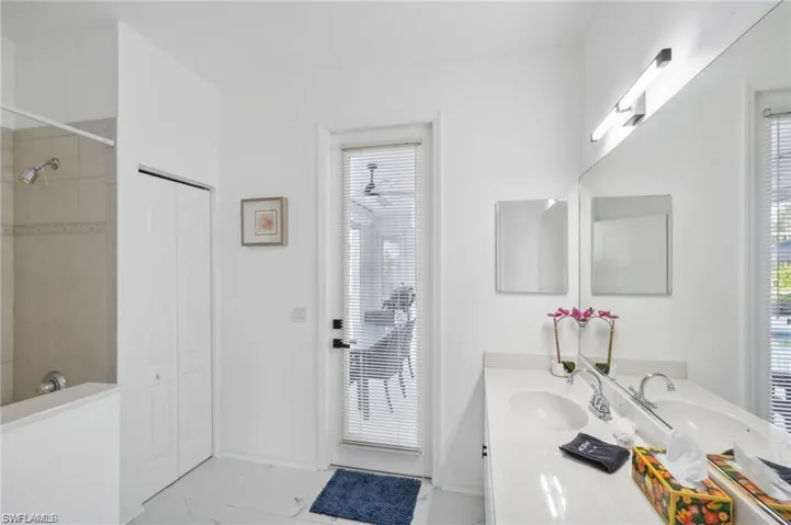 Full bathroom with a shower, marble finish floor, vanity, and baseboards