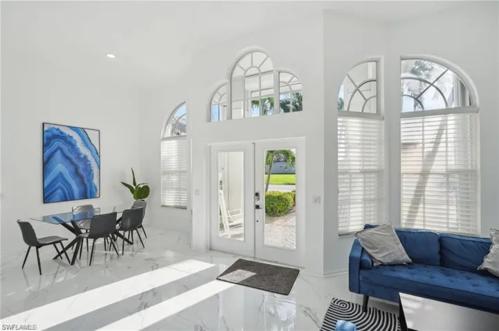Foyer featuring marble finish floor, baseboards, recessed lighting, and french doors