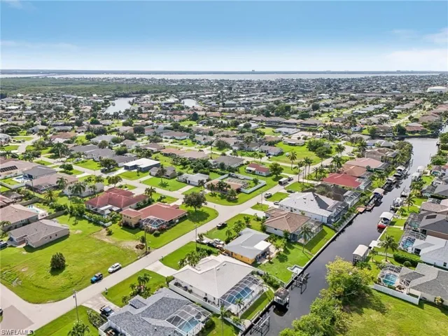 Drone / aerial view with a residential view and a water view