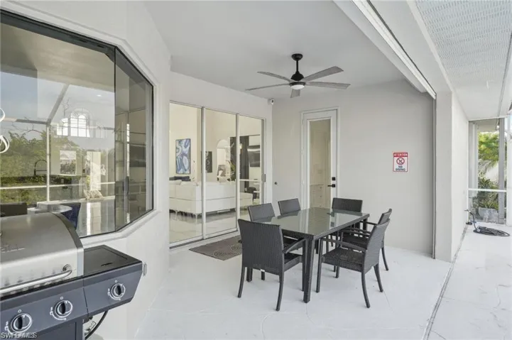 View of patio / terrace with outdoor dining space, area for grilling, and ceiling fan