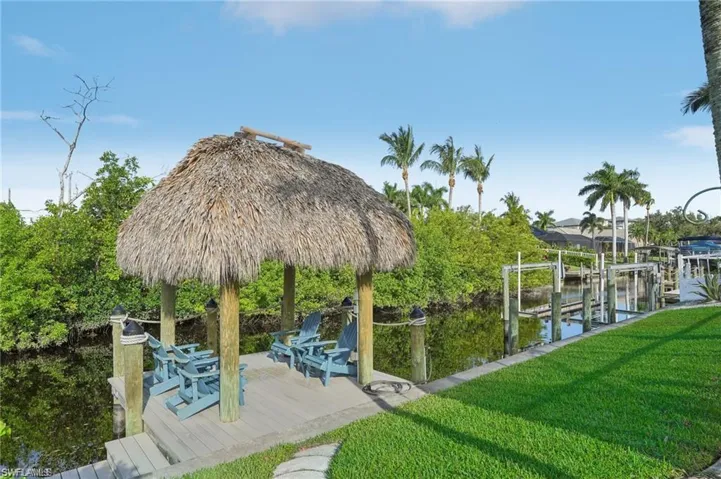 Dock area featuring a lawn and boat lift