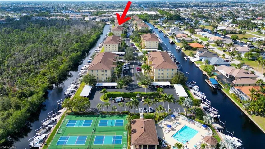 Birds eye view of property with a water view