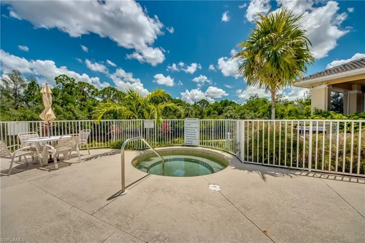 View of pool featuring a community hot tub and a patio