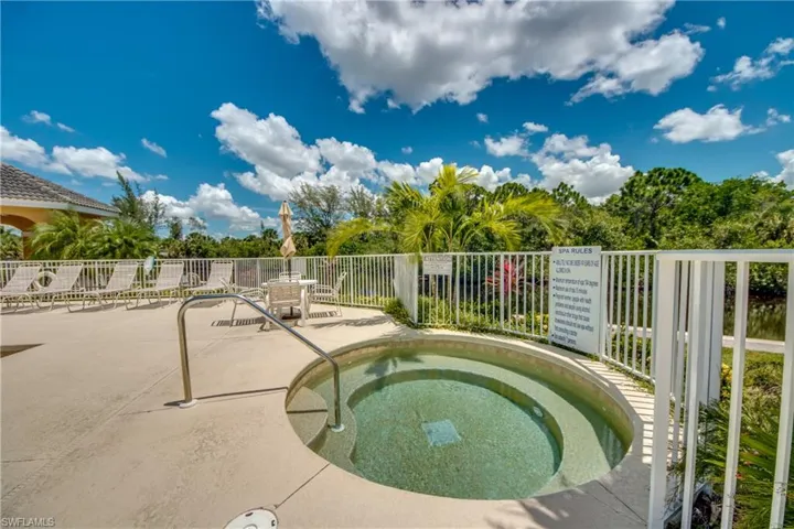 View of pool featuring a hot tub